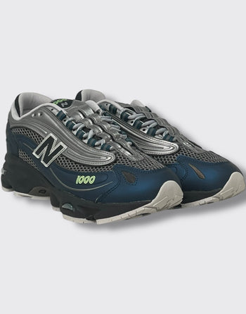 Quattro Stagioni Lifestyle 1000 navy blue and silver mesh sneakers with green accents.