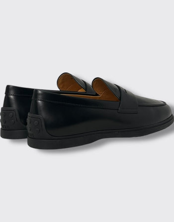 Quattro Stagioni black leather slip-on loafers with rubber sole and iconic pebble detailing on the heel.