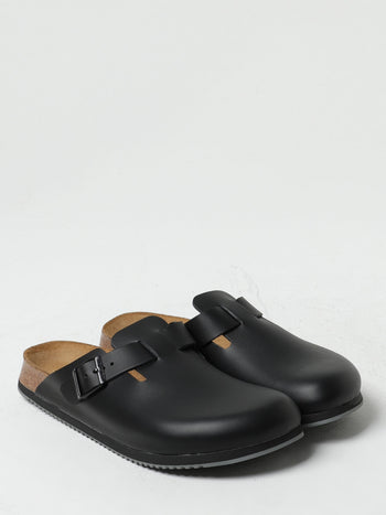 Quattro Stagioni black leather clogs with adjustable buckle strap and cork footbed. Comfortable slip-on shoes.