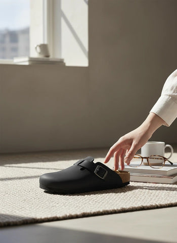 Quattro Stagioni black leather Birkenstock Boston clogs with adjustable buckle and cork footbed.